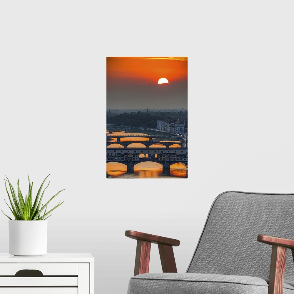 A modern room featuring Orange sky above the river and bridges, color photography