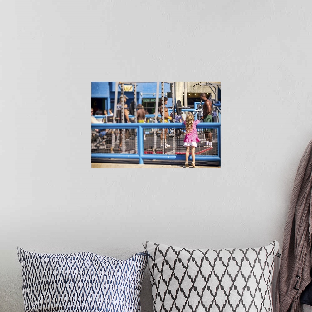 A bohemian room featuring Curiosity, Muscle Beach, young girl watching muscle men, color photograph