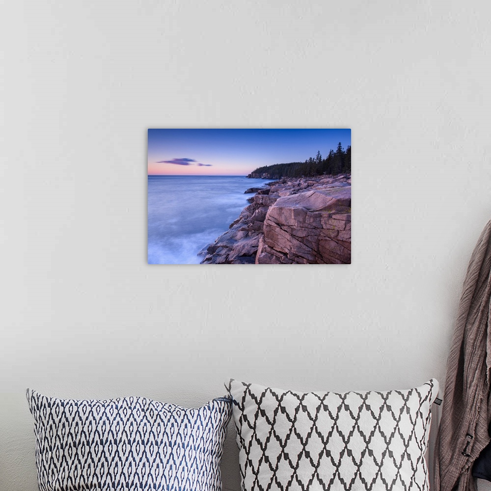 A bohemian room featuring Long exposure photograph of an ocean leading up to rocky cliffs\ early in the morning.