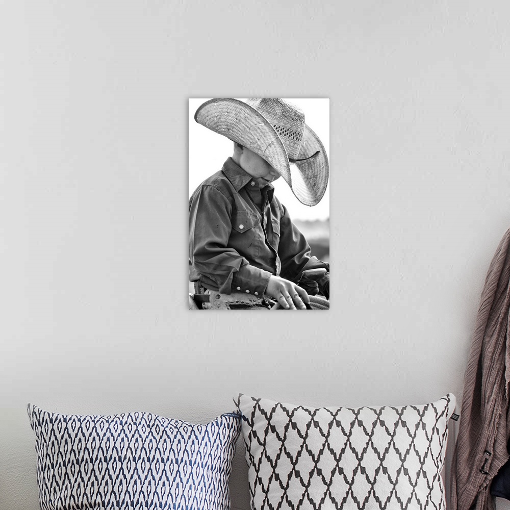 A bohemian room featuring Young cowboy looking pensive in the saddle
