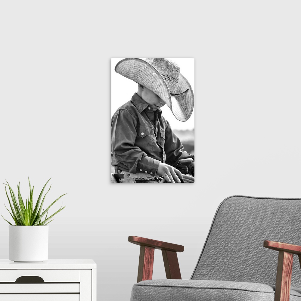 A modern room featuring Young cowboy looking pensive in the saddle