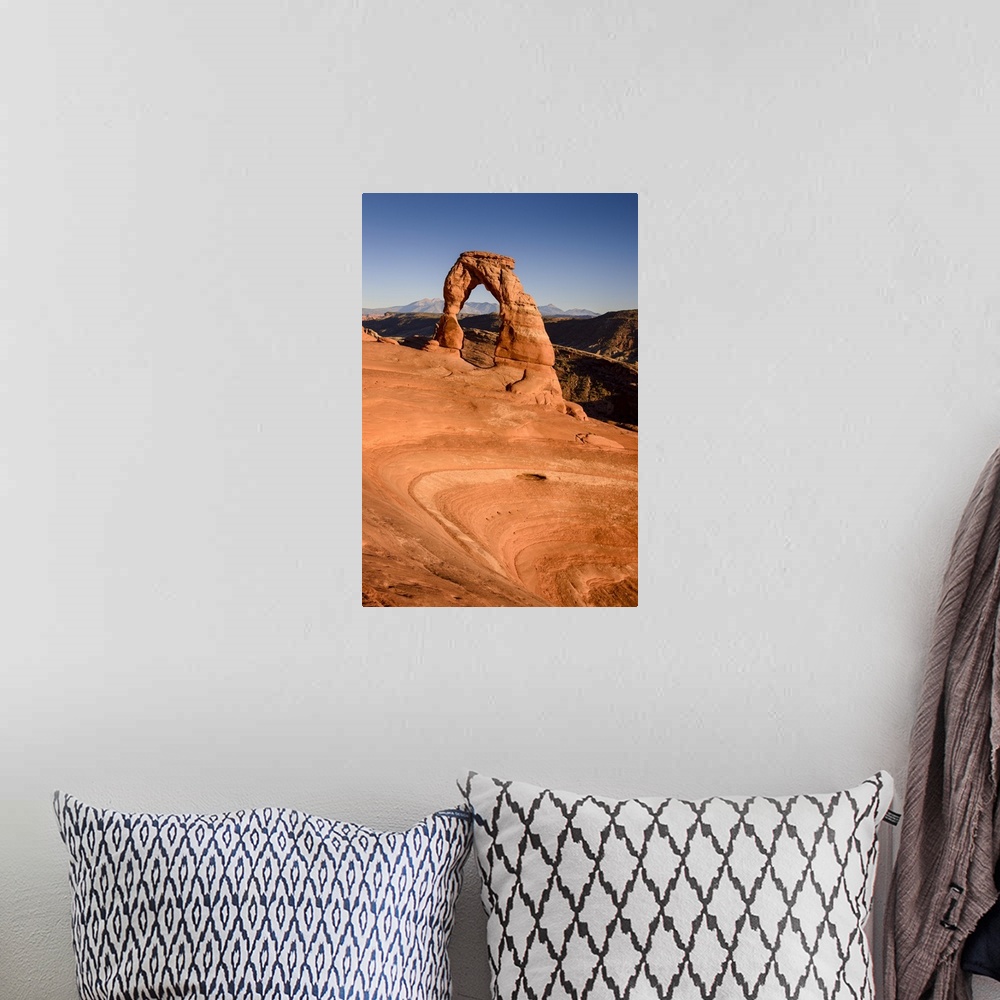 A bohemian room featuring A photograph of the delicate arch in Utah's Arches national park.