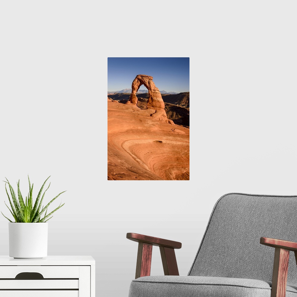 A modern room featuring A photograph of the delicate arch in Utah's Arches national park.