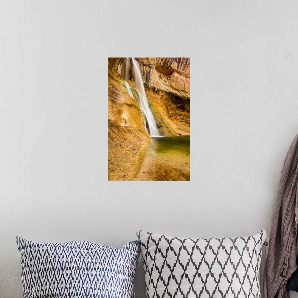 A bohemian room featuring A photograph of a small waterfall streaming down a desert rock wall in an oasis.