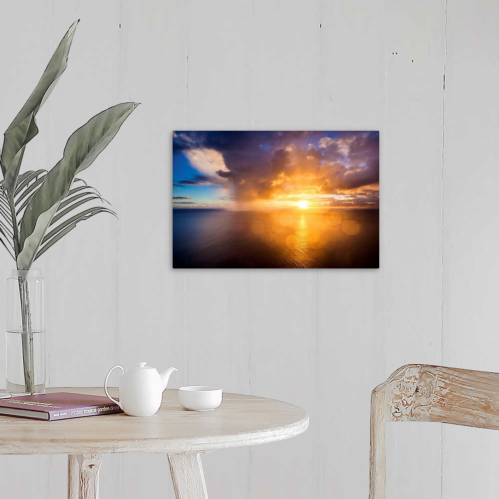 A farmhouse room featuring A photograph of a Hawaiian sunset over the ocean.