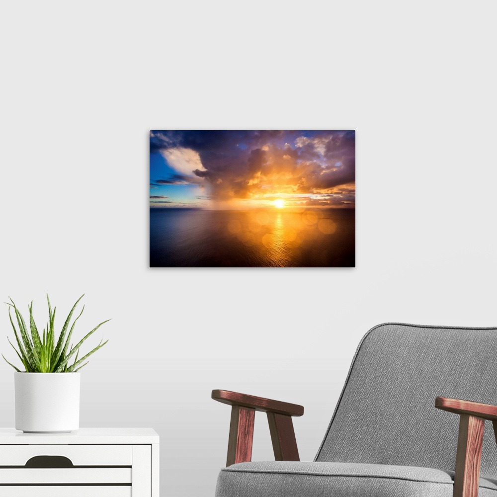 A modern room featuring A photograph of a Hawaiian sunset over the ocean.