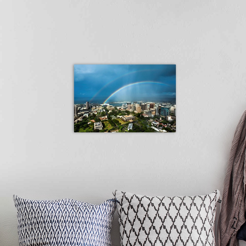 A bohemian room featuring A photograph over the downtown area of Honolulu under a double rainbow.