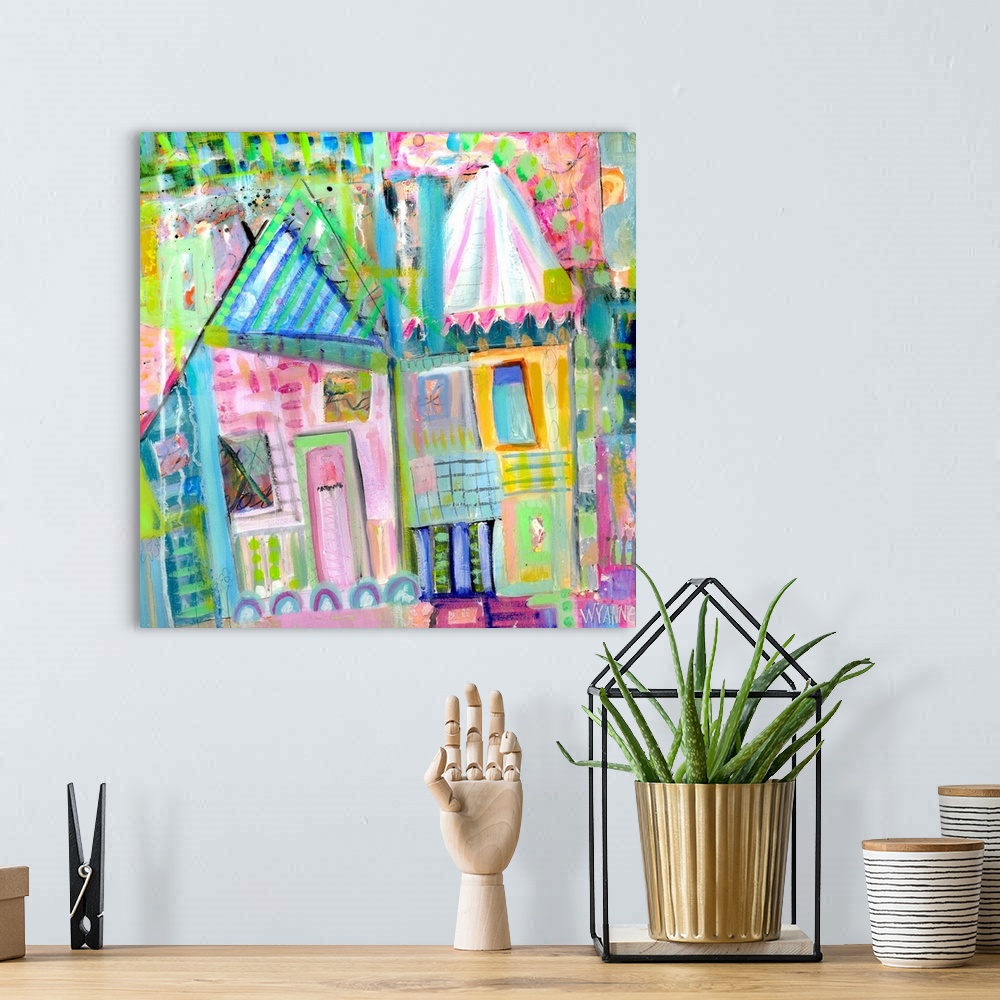 A bohemian room featuring Two pastel colored houses in shades of green, pink, and blue.