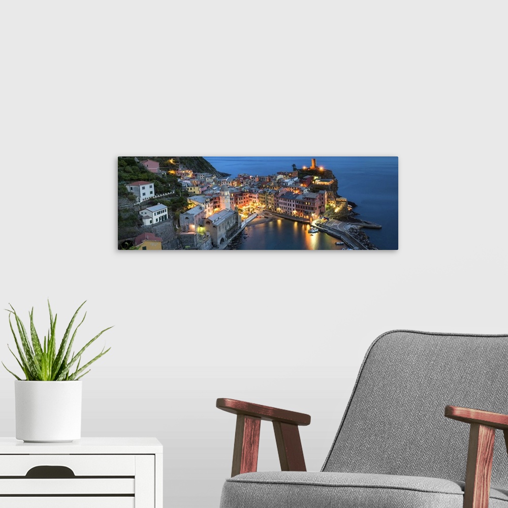 A modern room featuring A photograph of an Italian coastal village atop a cliff.