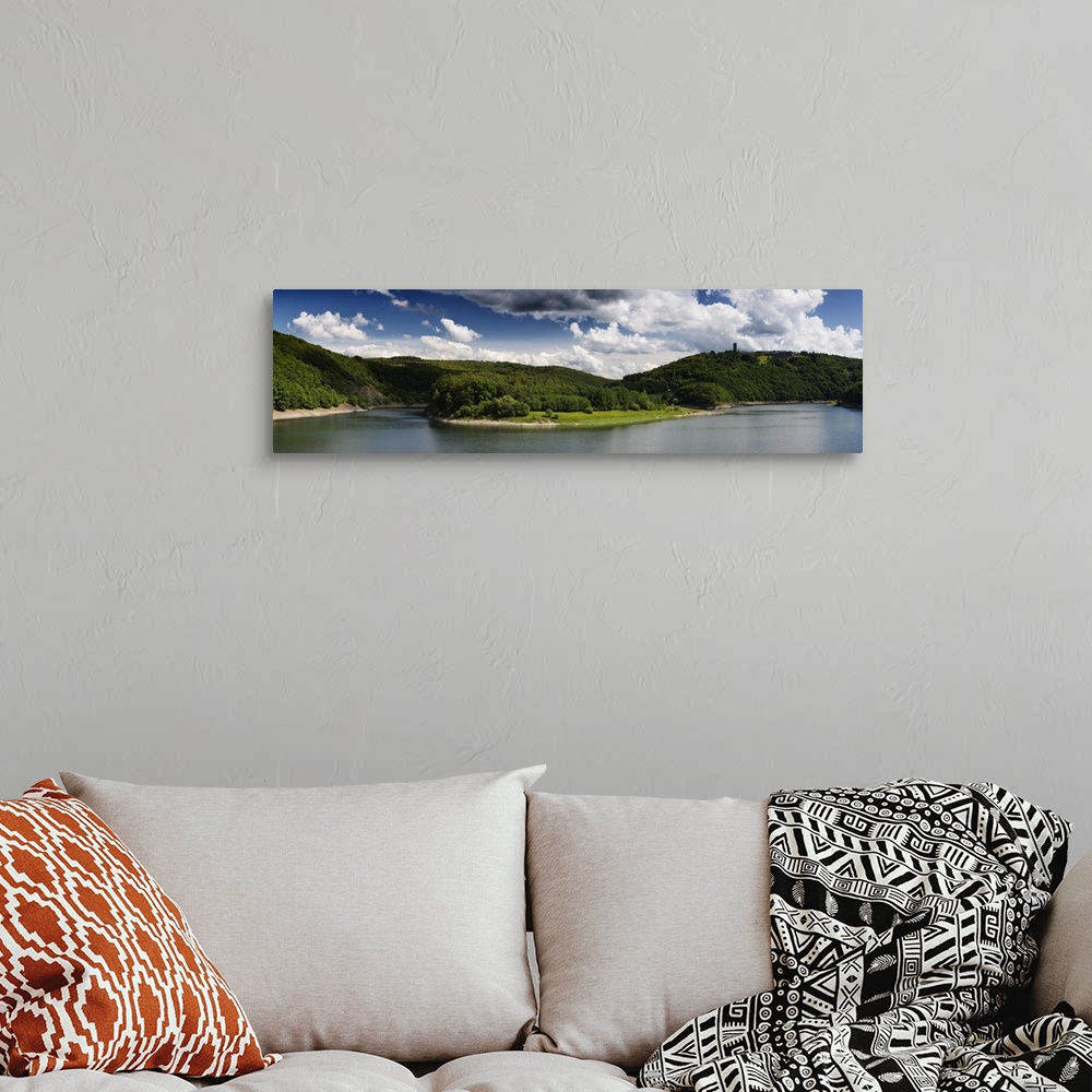 A bohemian room featuring Panoramic photograph of a lake in the Eifel range in Germany under cloudy skies.