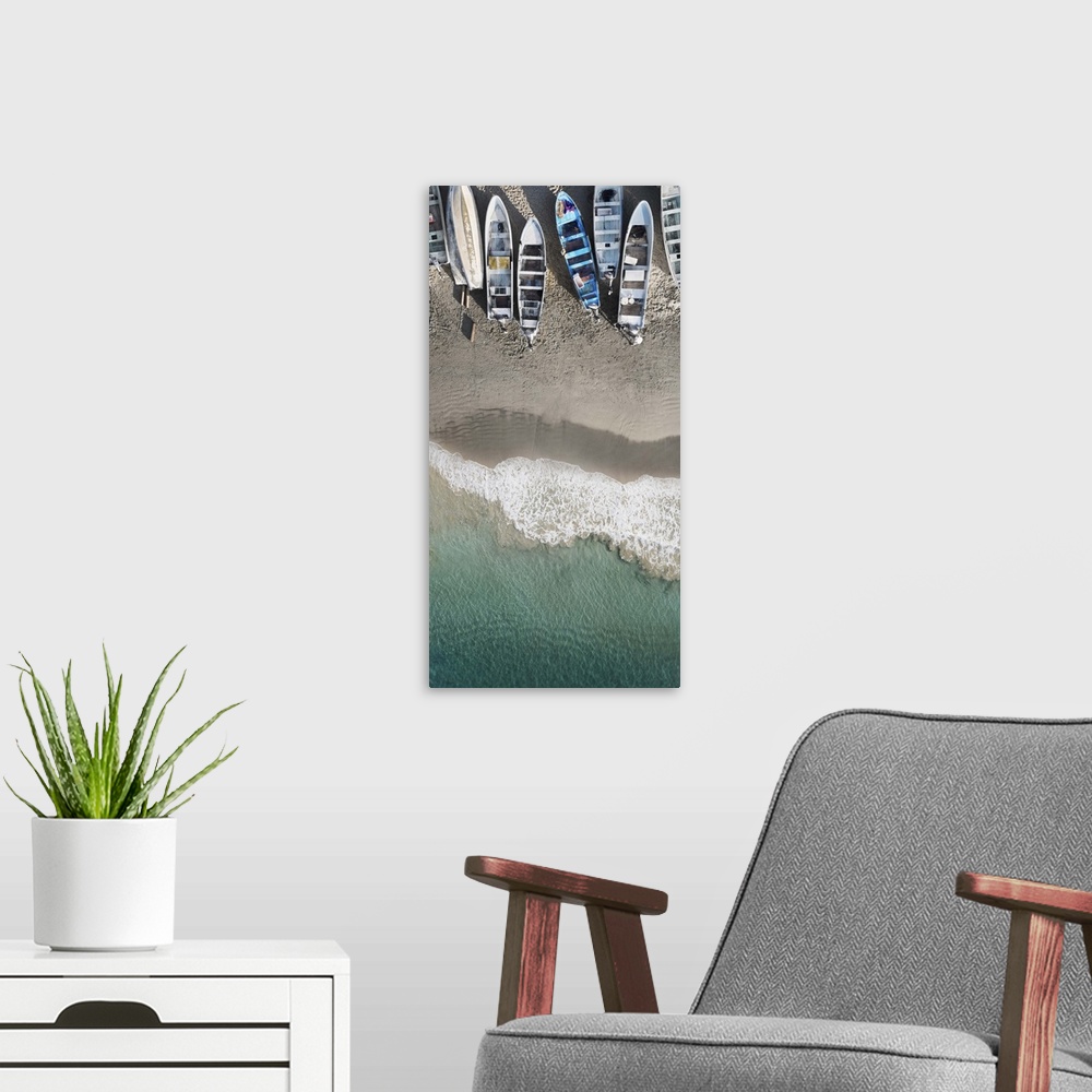 A modern room featuring An artistic aerial photograph of a beach with rowboats sitting on the shoreline.