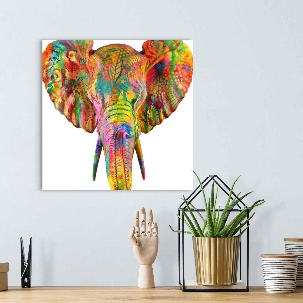 A bohemian room featuring Colorful painting of an elephant's head and tusk covered in abstract designs on a sold white back...