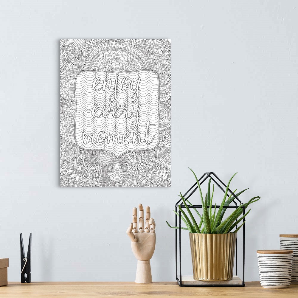 A bohemian room featuring Black and white line art with the phrase "Enjoy Every Moment" written on top of an intricately de...