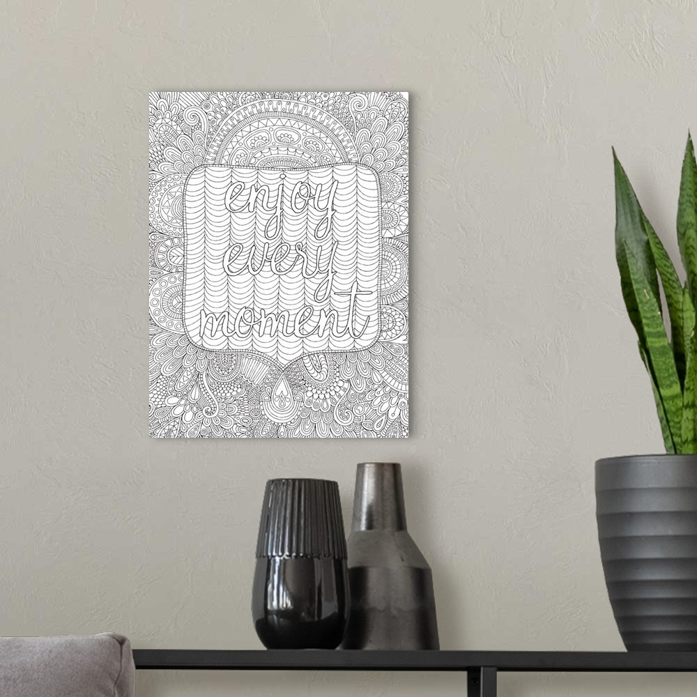 A modern room featuring Black and white line art with the phrase "Enjoy Every Moment" written on top of an intricately de...