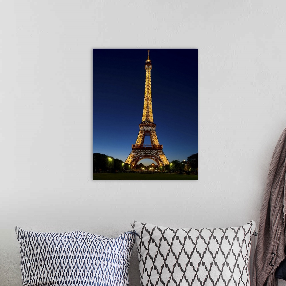 A bohemian room featuring A photograph of the Eiffel Tower seen at night.