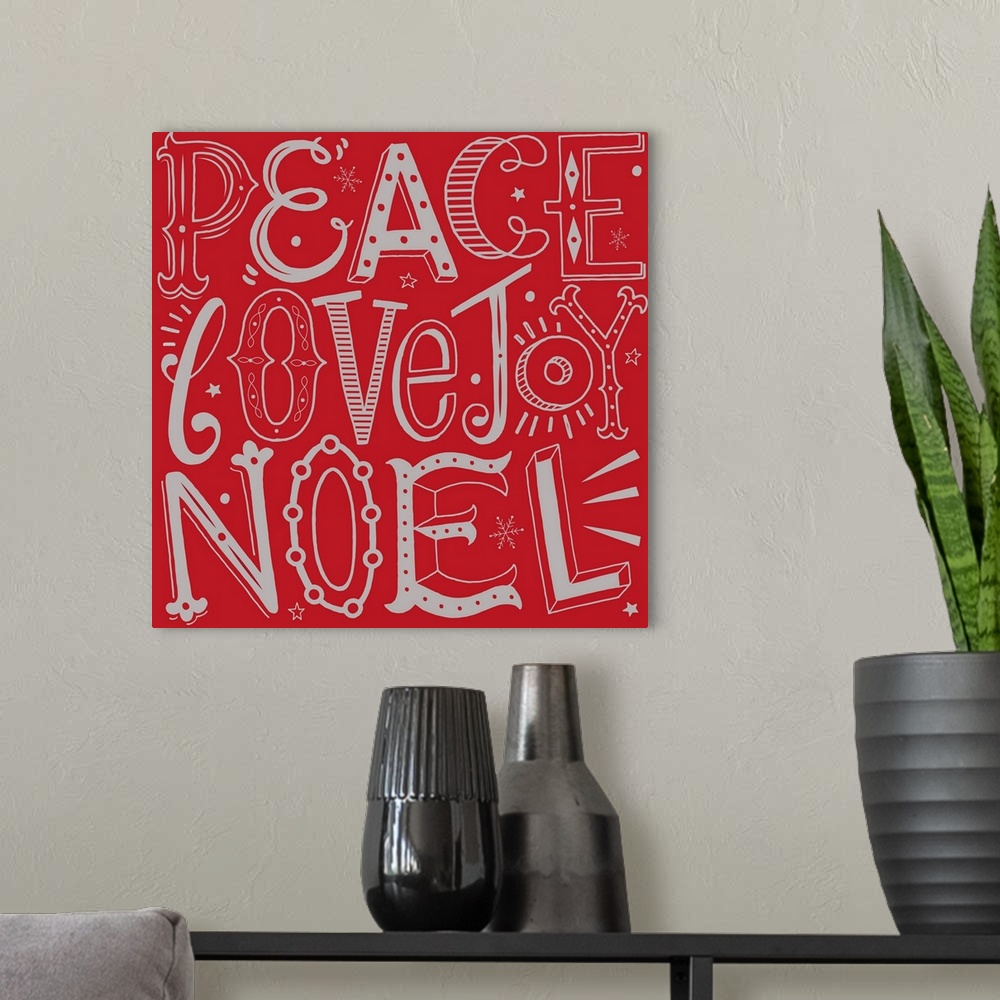 A modern room featuring Holiday themed typography art with festive lettering against a red background.