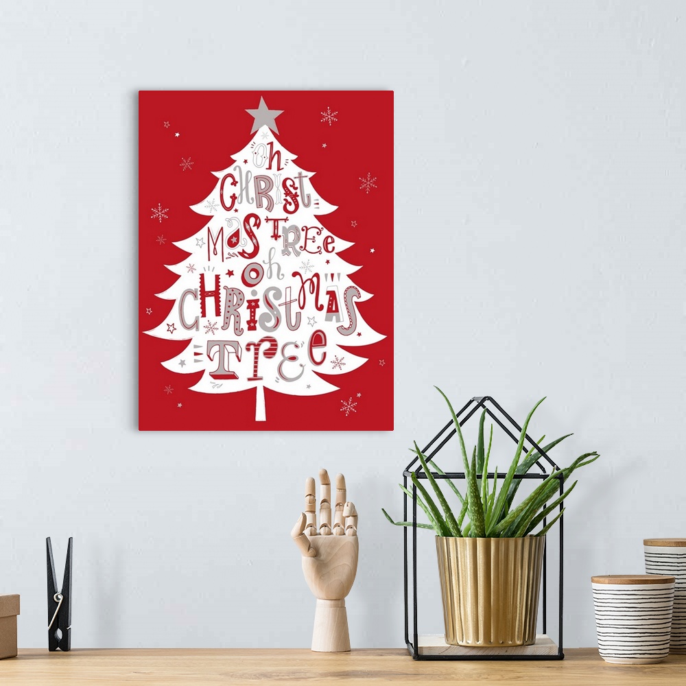 A bohemian room featuring Holiday themed typography art with festive lettering against a red background.