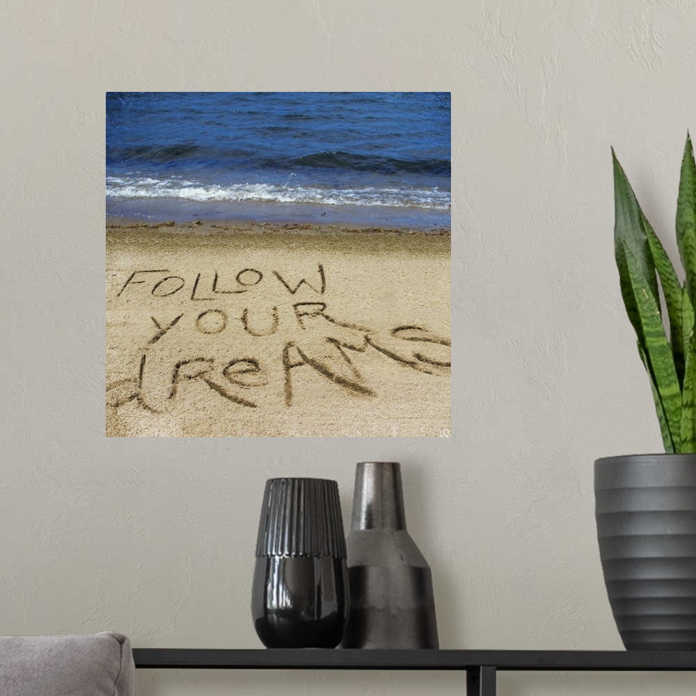 A modern room featuring Photograph of a motivational sentiment written in the sand on a beach.