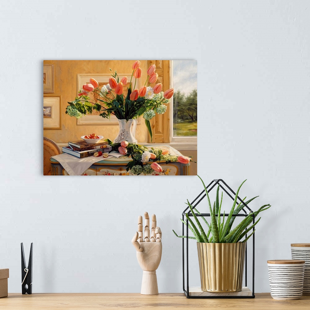 A bohemian room featuring Vase of french tulips and assorted flowers on a table with books on it and a window in the backgr...