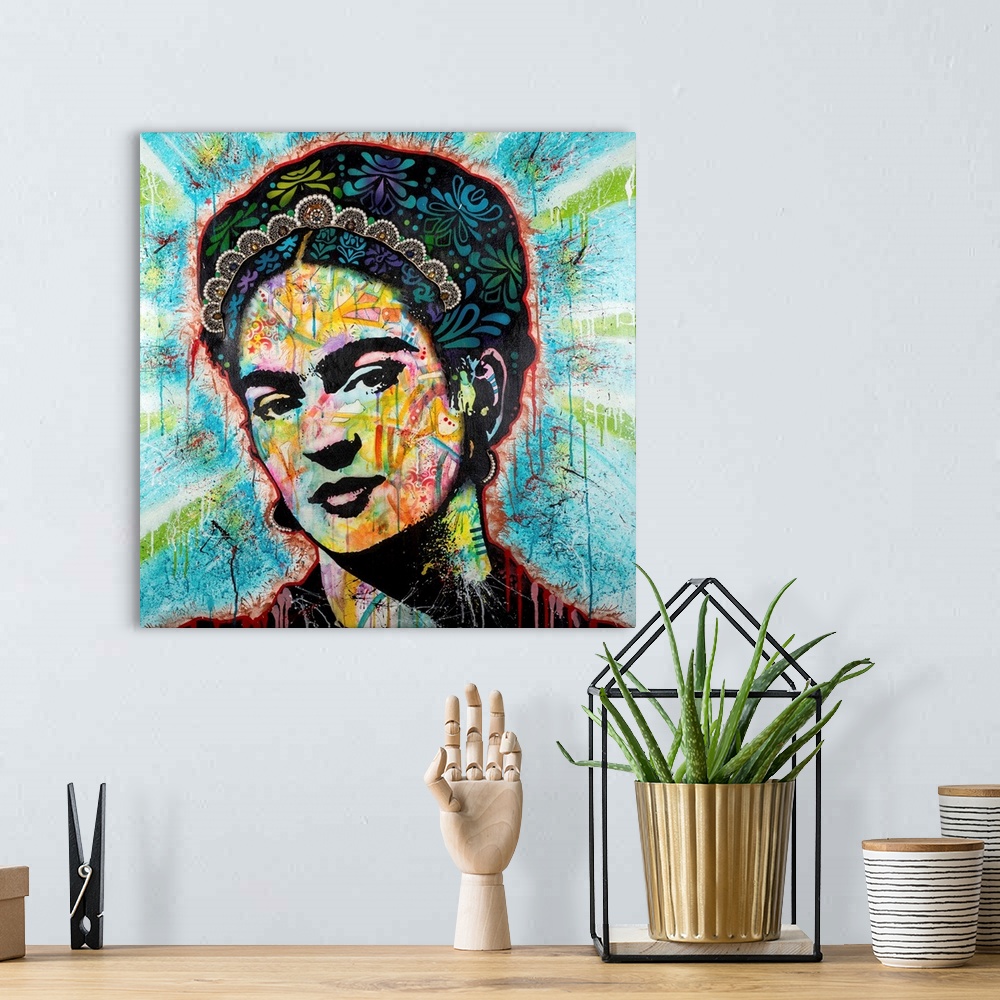 A bohemian room featuring Pop art style art with a portrait of Frida outlined in red drippy paint on a blue background with...