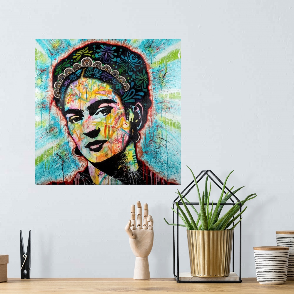 A bohemian room featuring Pop art style art with a portrait of Frida outlined in red drippy paint on a blue background with...