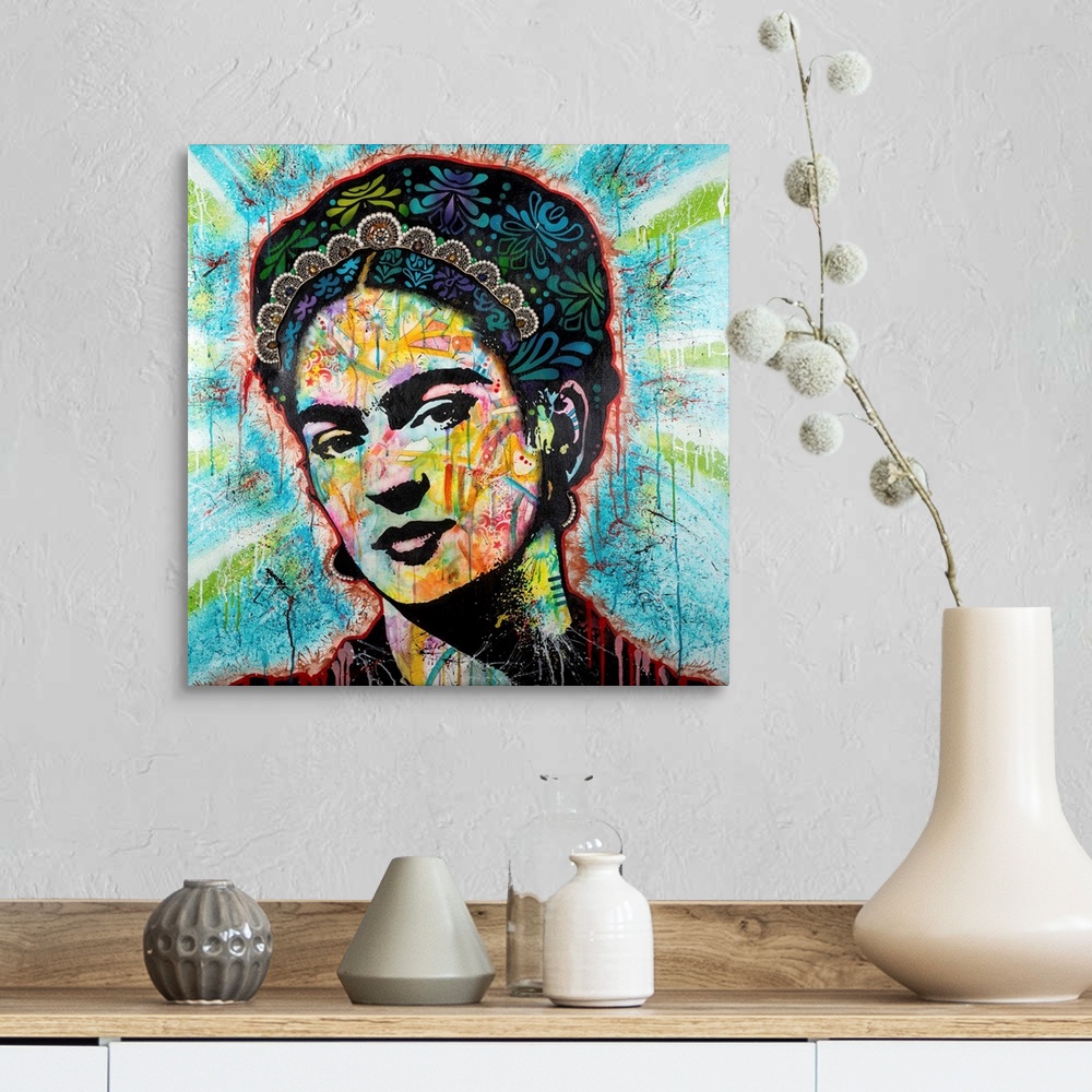 A farmhouse room featuring Pop art style art with a portrait of Frida outlined in red drippy paint on a blue background with...