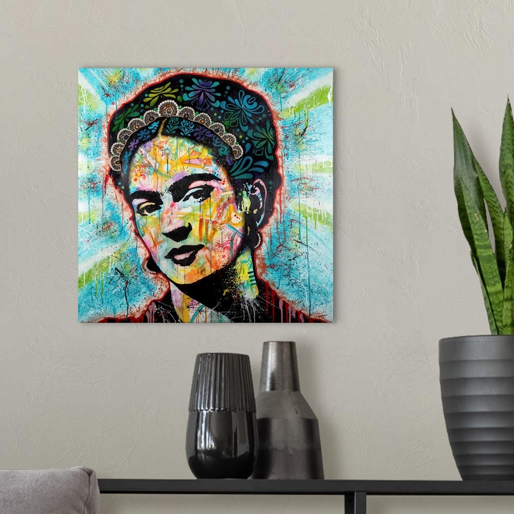 A modern room featuring Pop art style art with a portrait of Frida outlined in red drippy paint on a blue background with...