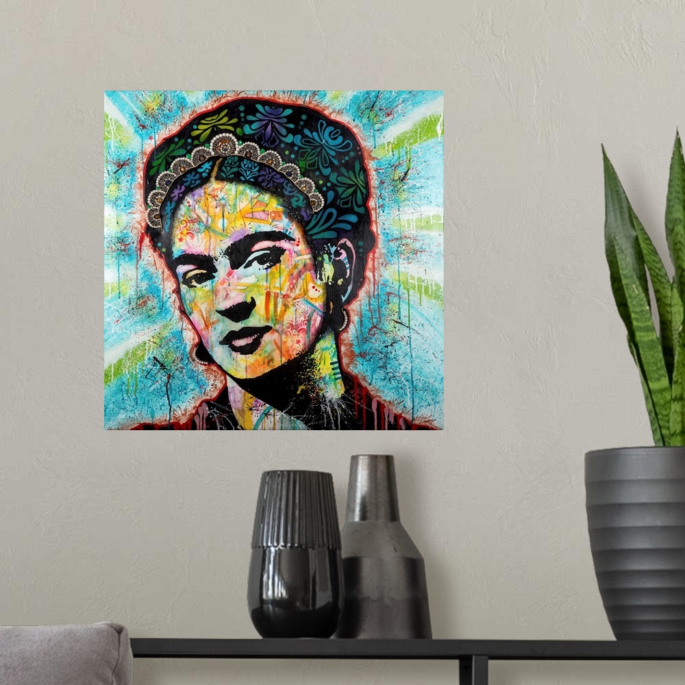 A modern room featuring Pop art style art with a portrait of Frida outlined in red drippy paint on a blue background with...