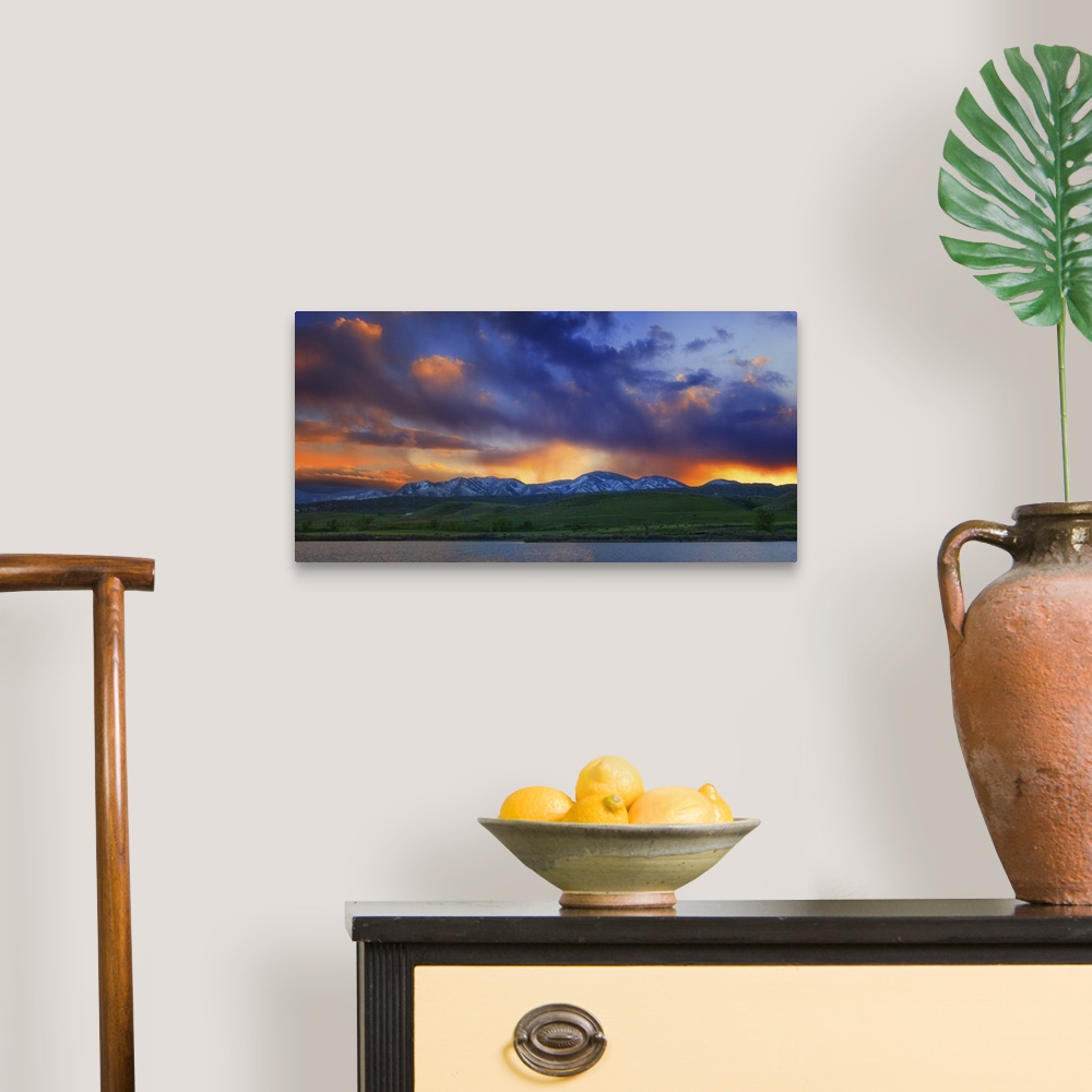 A traditional room featuring Vivid clouds at sunset over a mountain range.