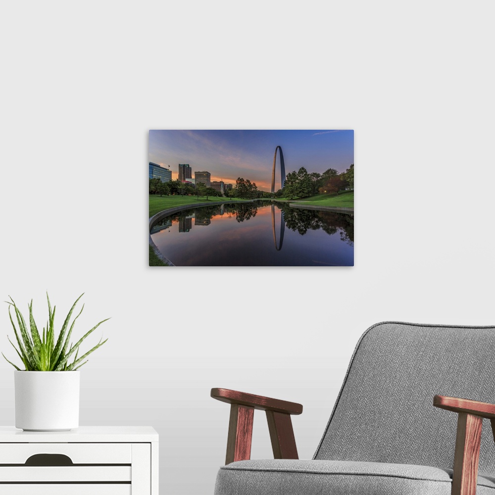 A modern room featuring A photograph of a St. Louis Missouri at sunset.