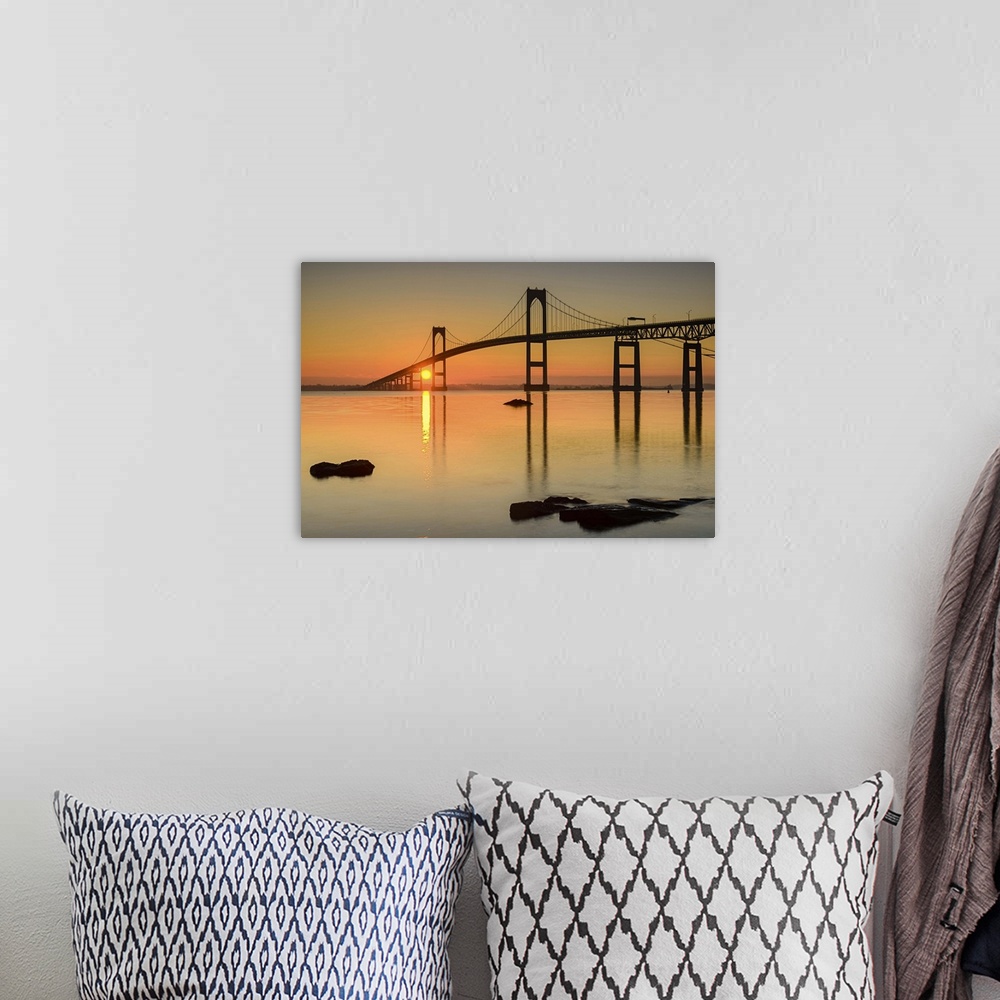 A bohemian room featuring A photograph of a large suspension bridge silhouetted at sunset.