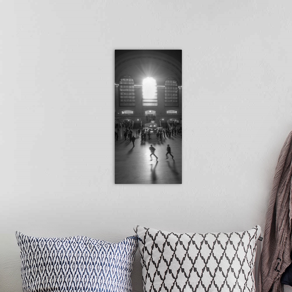 A bohemian room featuring An artistic black and white photograph of silhouetted people inside Grand Central Station.