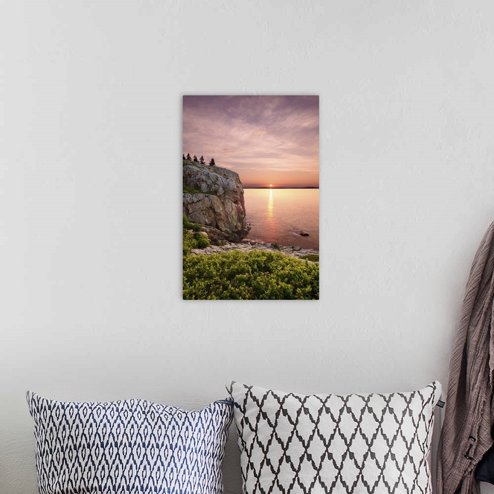 A bohemian room featuring An artistic photograph of a cliff-side view of a sunset out to sea.