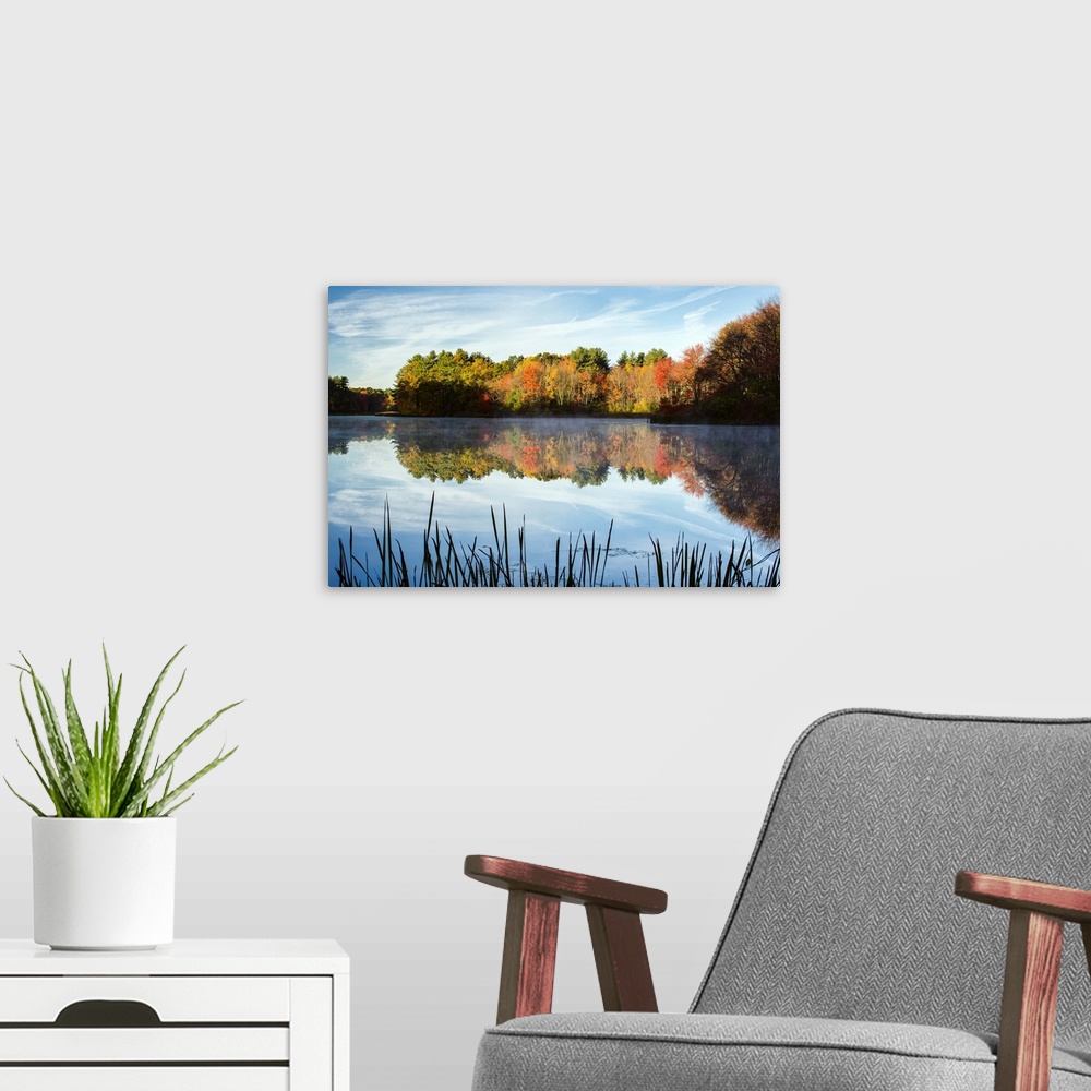 A modern room featuring Landscape photograph of Grist Millpond, Massachusetts, with Fall trees reflecting on to the water.