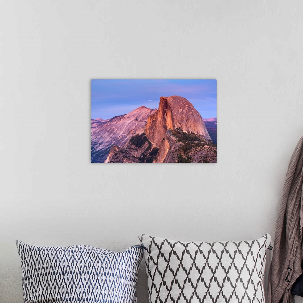A bohemian room featuring Half Dome in Yosemite bathed in pink light from the sunset.