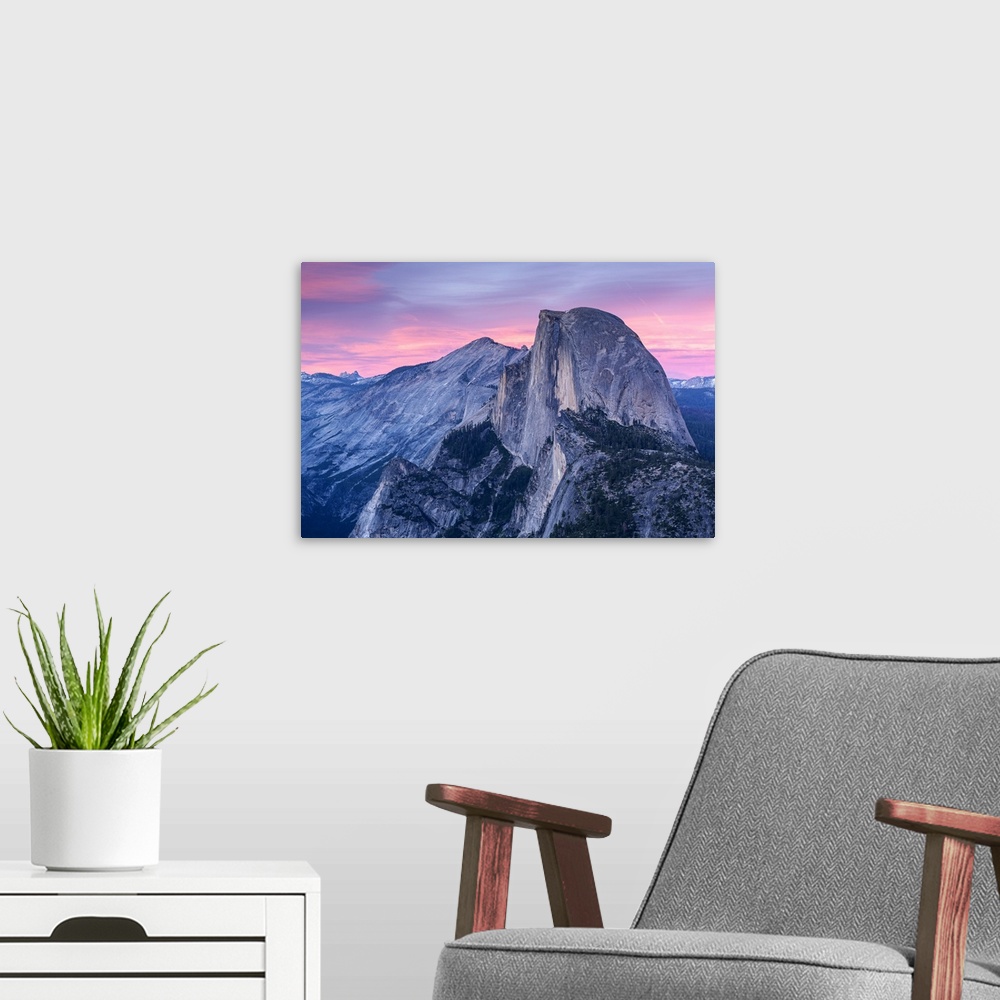 A modern room featuring Half Dome in Yosemite with pink clouds in the sky.