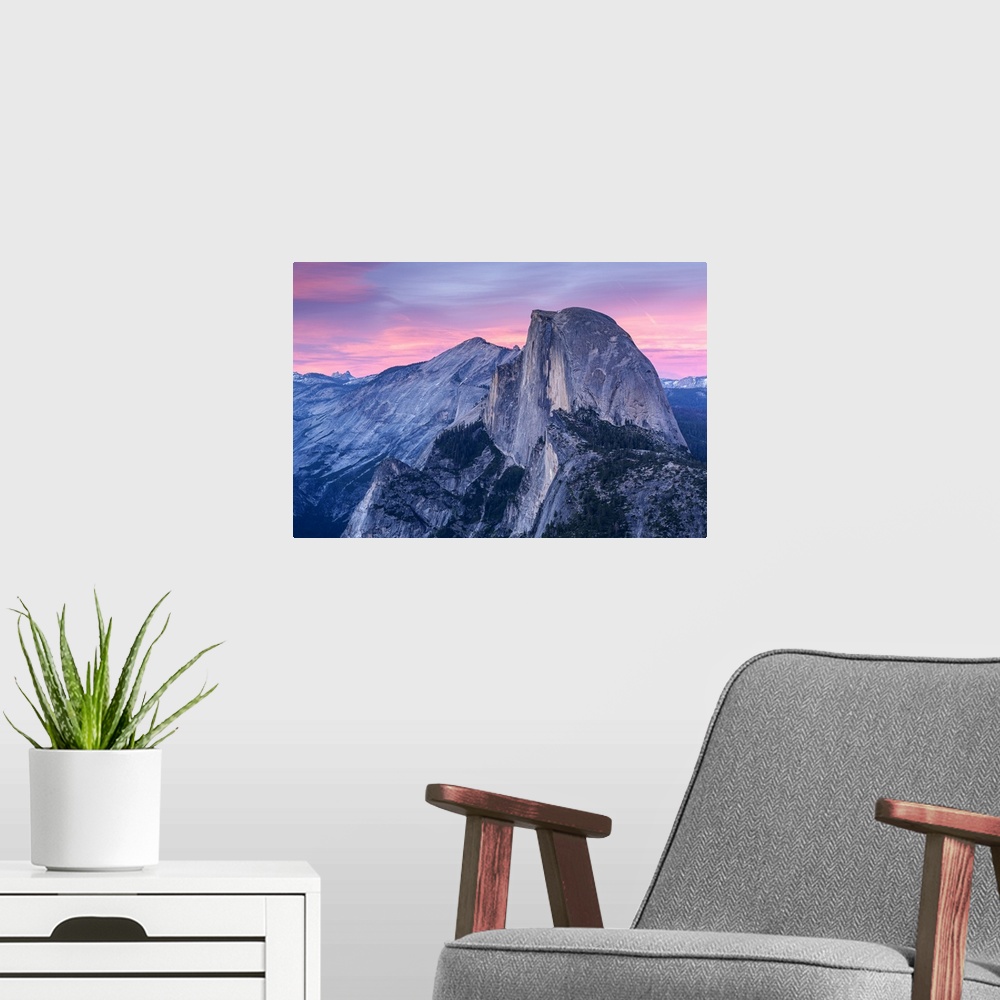 A modern room featuring Half Dome in Yosemite with pink clouds in the sky.