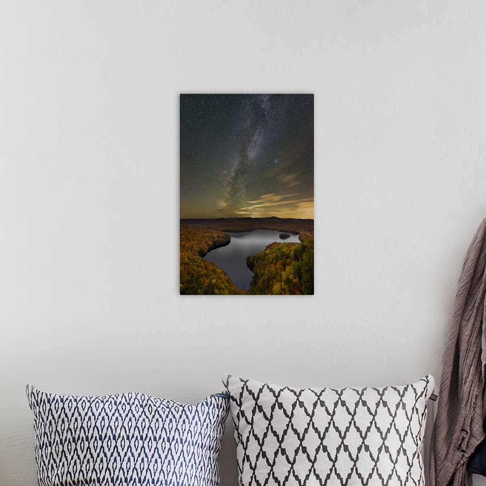 A bohemian room featuring A photograph of a serene wilderness landscape under a night sky.