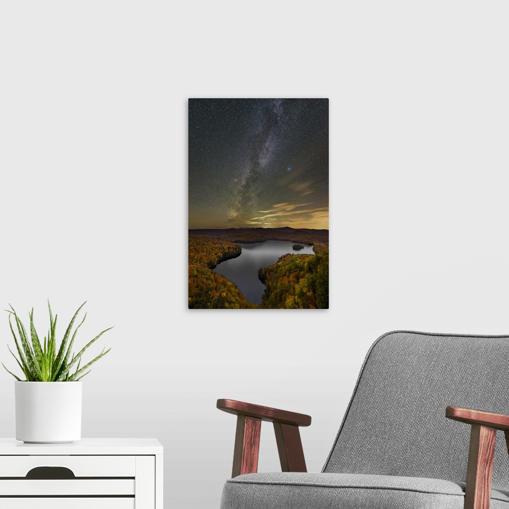 A modern room featuring A photograph of a serene wilderness landscape under a night sky.