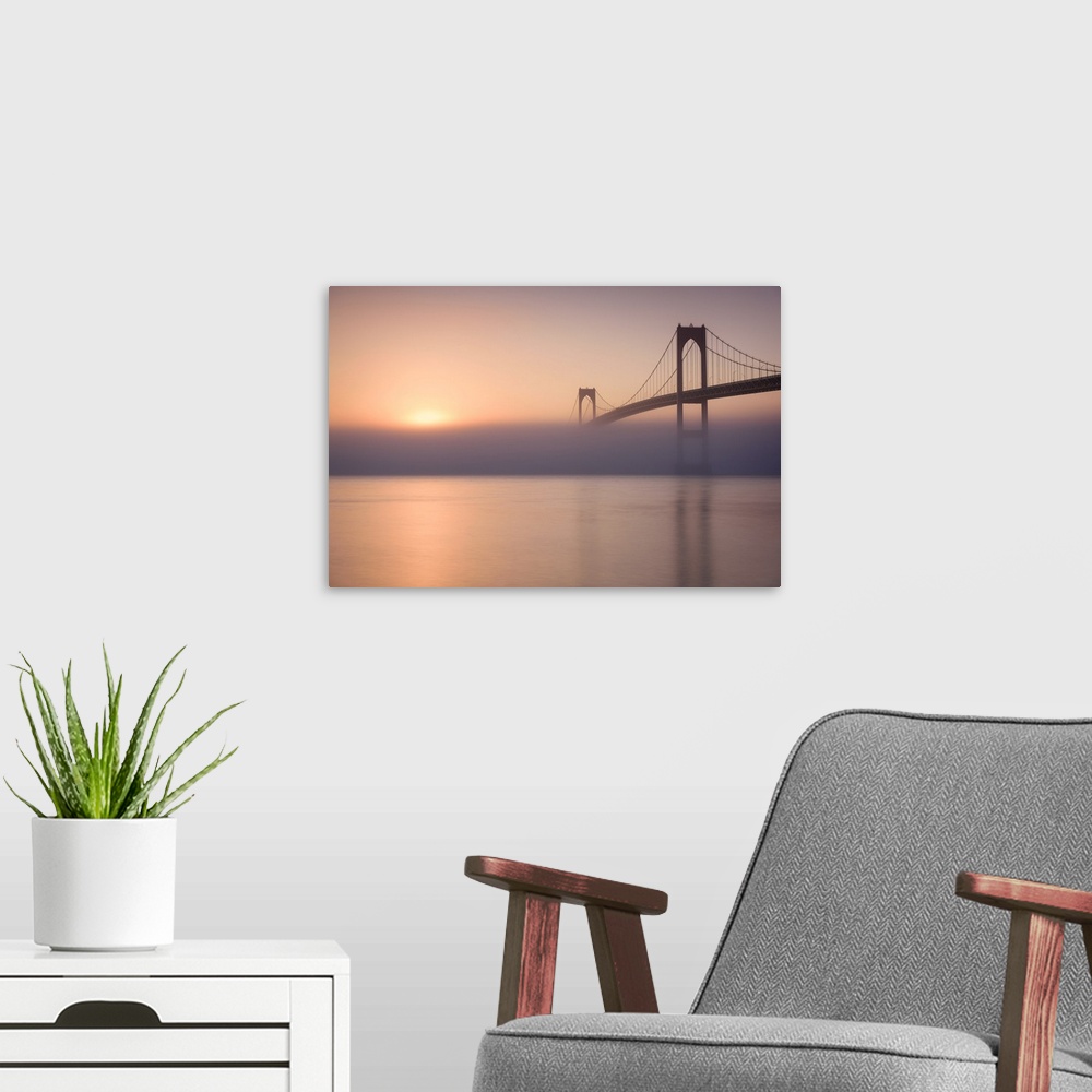 A modern room featuring Beautiful photograph of the Golden Gate Bridge with heavy fog over the Bay and a warm sunrise.