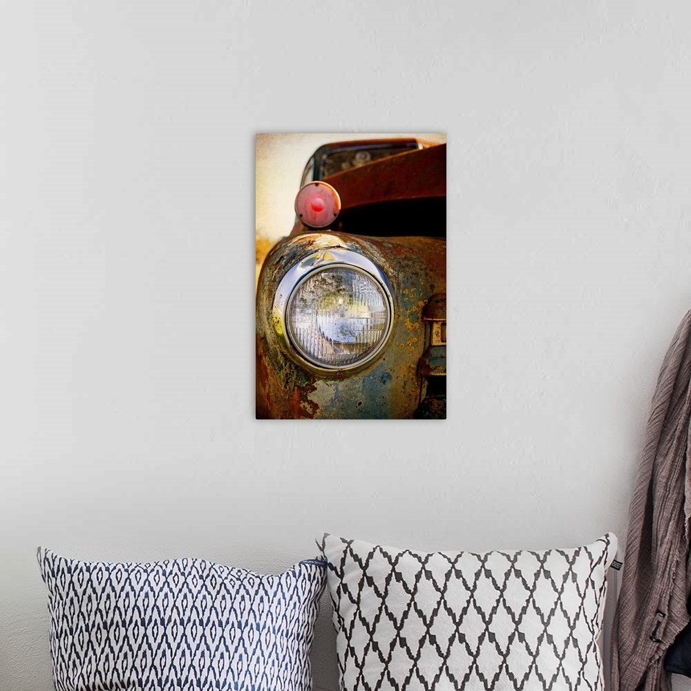 A bohemian room featuring Photograph of a headlight of on the front of a vintage car.