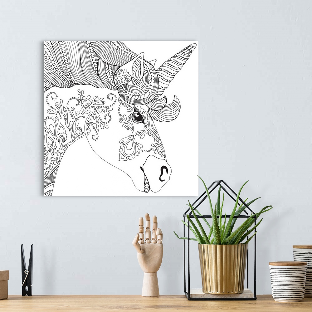 A bohemian room featuring Contemporary line art of the head of a unicorn with uniquely designed patterns on the face and neck.