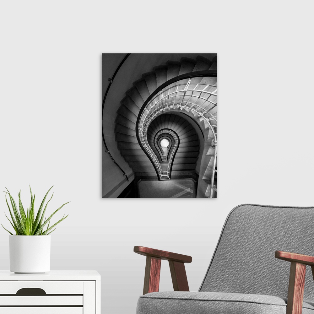 A modern room featuring black and white photograph, stairs, spiral staircase, lightbulb
