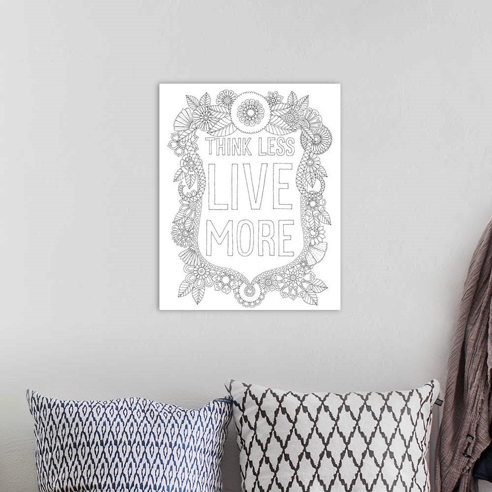 A bohemian room featuring Black and white line art of a floral design with the phrase "Think Less Live More" written in the...
