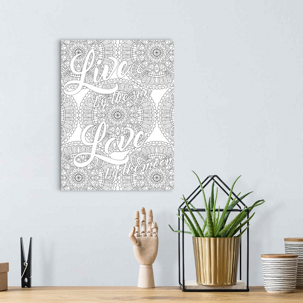 A bohemian room featuring Inspirational black and white line art with the phrase "Live by the Sun Love by the Moon" written...