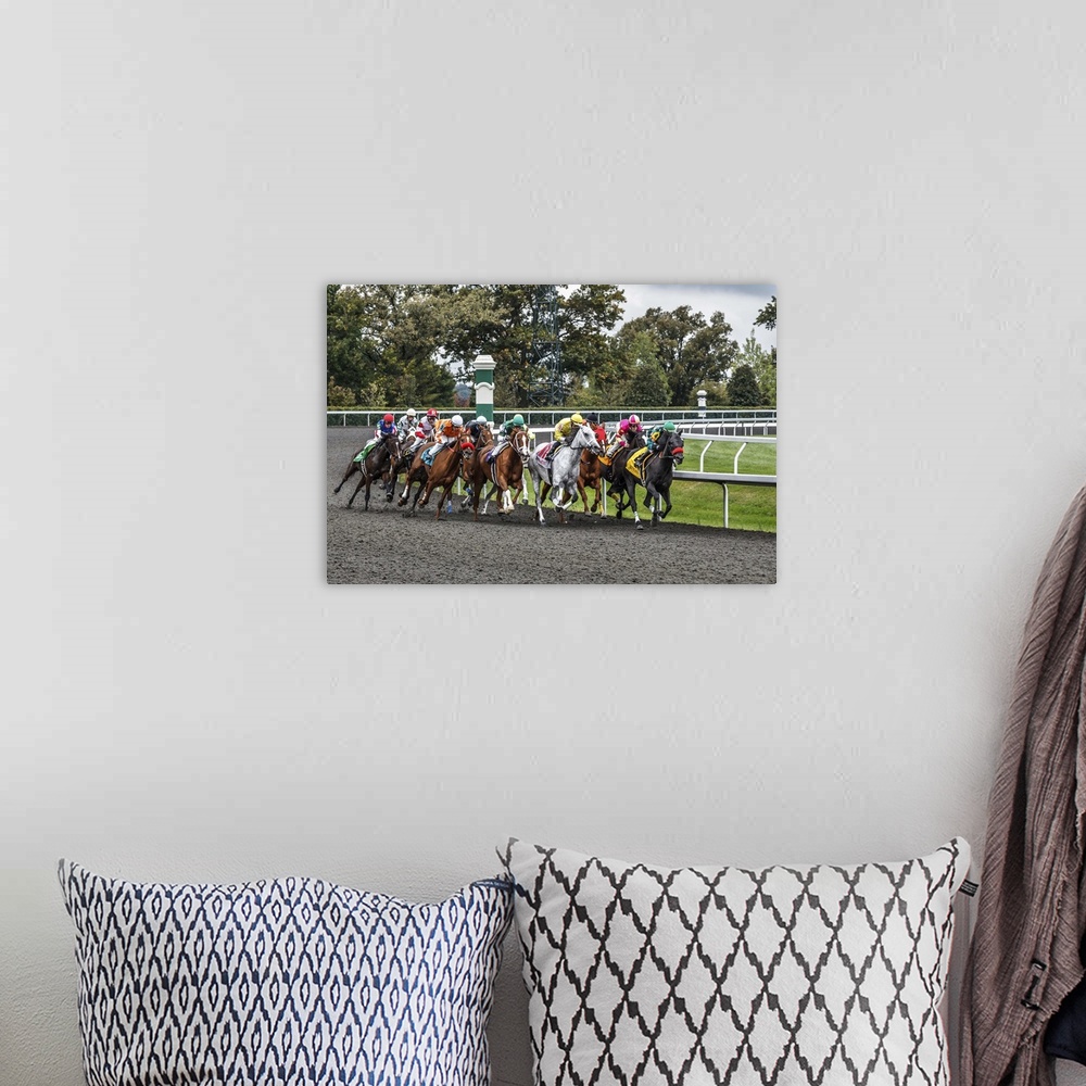 A bohemian room featuring Photograph of a a horse race at full speed rounding a curve.