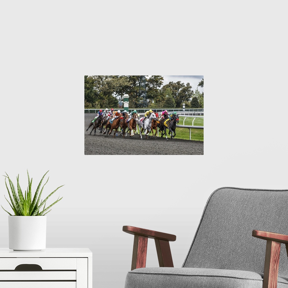 A modern room featuring Photograph of a a horse race at full speed rounding a curve.
