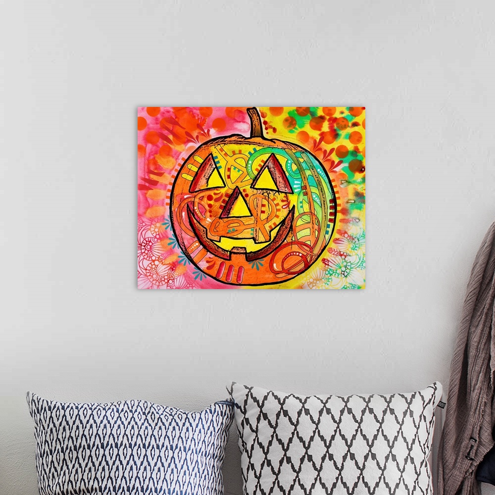 A bohemian room featuring Brightly colored painting of a jack o lantern surrounded by abstract designs.