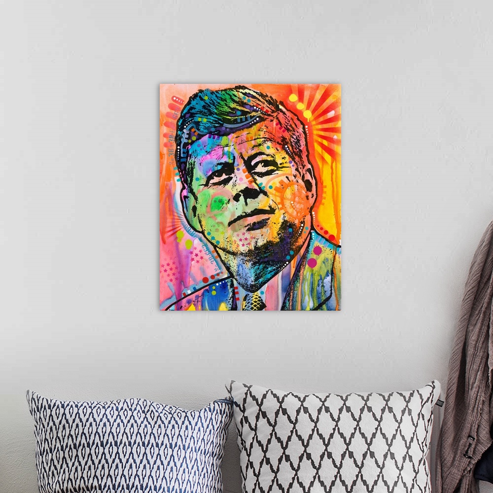 A bohemian room featuring Pop art style painting of John F. Kennedy with different colors and abstract designs all over.