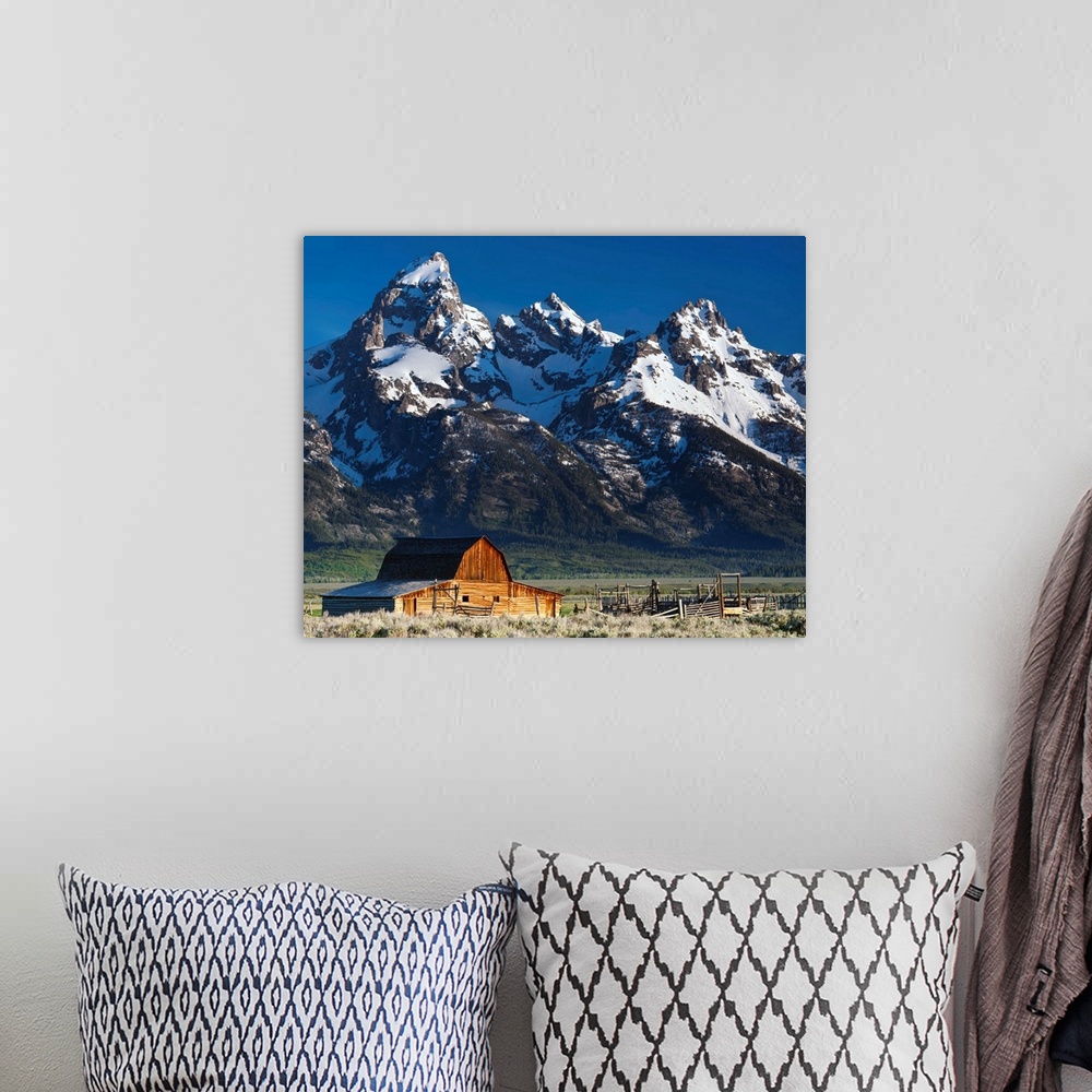 A bohemian room featuring A photograph of a the Grand Teton national park.